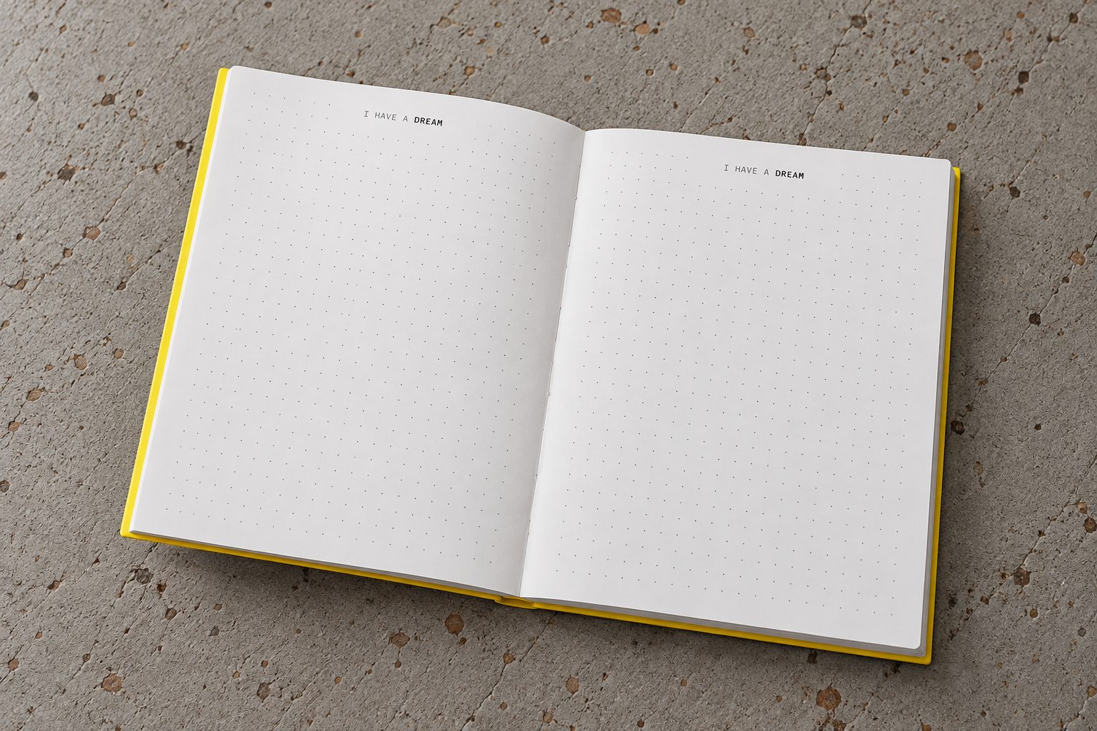 Caderno amarelo aberto, com páginas de pontos